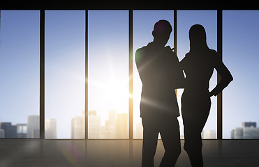 Image showing silhouettes of business partners over office