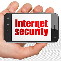 Image showing Safety concept: Hand Holding Smartphone with Internet Security on display