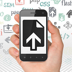 Image showing Web development concept: Hand Holding Smartphone with Upload on display