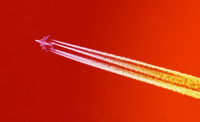 Image showing Plane in blue sky - Bright red and orange sky