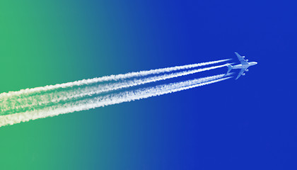 Image showing Plane in blue sky - Bright blue and green sky