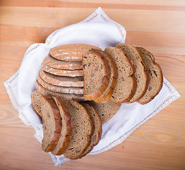 Image showing Freshly baked bread with homespun fabric 