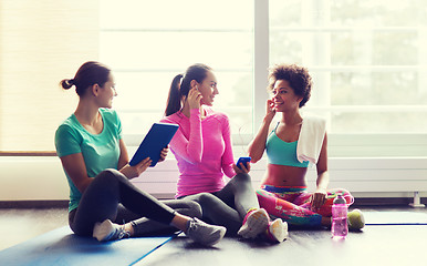 Image showing happy women listening to music in gym