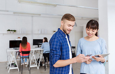 Image showing couple with smartphone and tablet pc at office