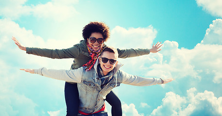 Image showing happy teenage couple in shades having fun outdoors