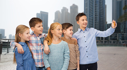 Image showing happy children talking selfie by smartphone