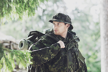 Image showing young soldier with backpack in forest