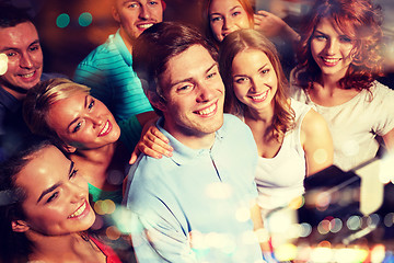 Image showing friends with smartphone taking selfie in club