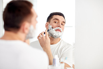 Image showing man shaving beard with razor blade at bathroom