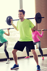 Image showing group of people exercising with barbell in gym