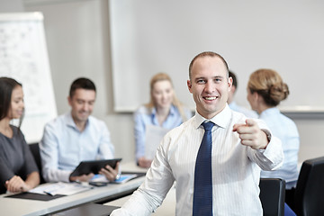 Image showing group of smiling businesspeople meeting in office