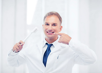 Image showing dentist with toothbrush in hospital