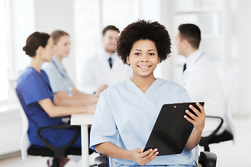 Image showing happy doctor over group of medics at hospital