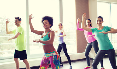 Image showing group of smiling people dancing in gym or studio