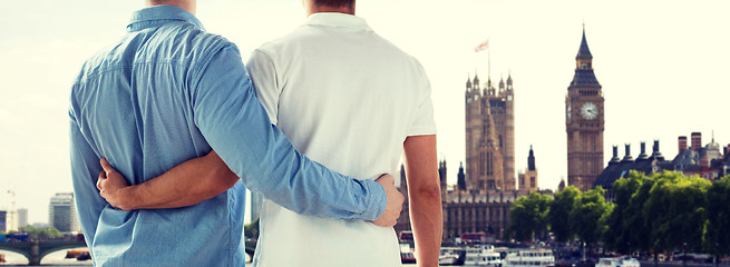 Image showing close up of male gay couple hugging over big ben