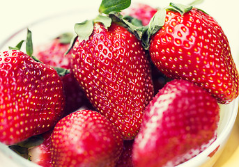 Image showing close up of ripe red strawberries over white