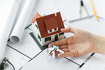 Image showing close up of hand with house keys and blueprint