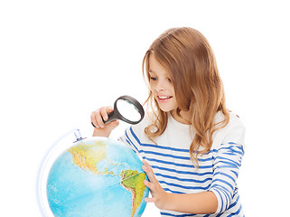 Image showing student girl looking at globe with magnifier