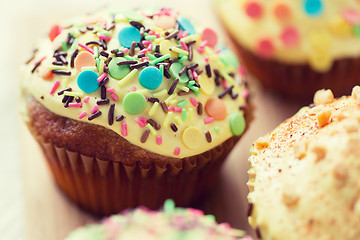 Image showing close up of glazed cupcakes or muffins on table