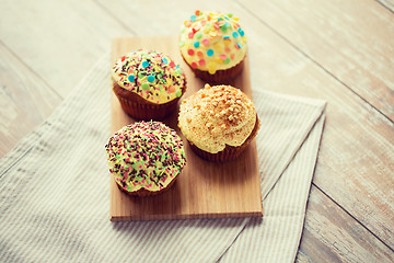 Image showing close up of glazed cupcakes or muffins on table
