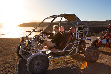 Image showing Woman driving quadbike in sunset.