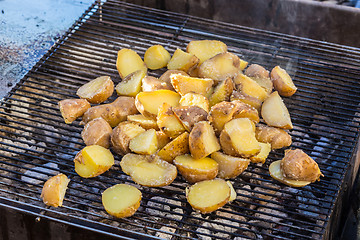 Image showing Roasted potatoes on barbeque.