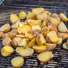 Image showing Roasted potatoes on barbeque.