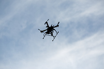 Image showing flying drone with camera on the sky