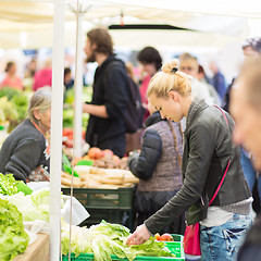 Image showing Woman buying vegetable at local food market. 