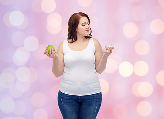 Image showing young plus size woman choosing apple or cookie