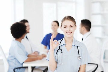 Image showing happy doctor over group of medics at hospital