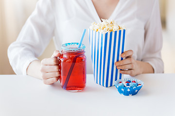 Image showing woman with popcorn and drink in glass mason jar