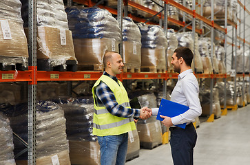 Image showing worker and businessmen with clipboard at warehouse