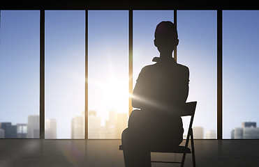 Image showing silhouette of business woman sitting on chair