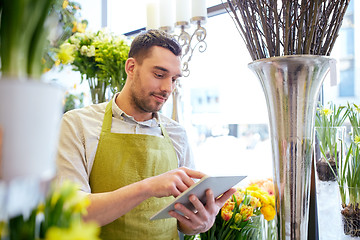 Image showing man with tablet pc computer at flower shop