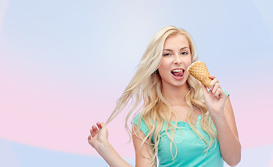 Image showing happy young woman in sunglasses eating ice cream