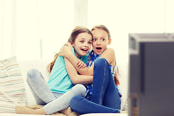 Image showing scared little girls watching horror on tv at home