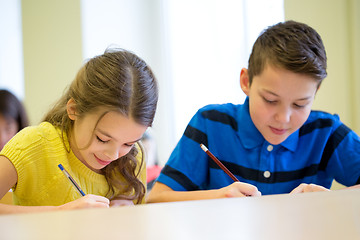 Image showing group of school kids writing test in classroom