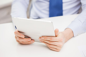 Image showing close up of businessman with tablet pc in office