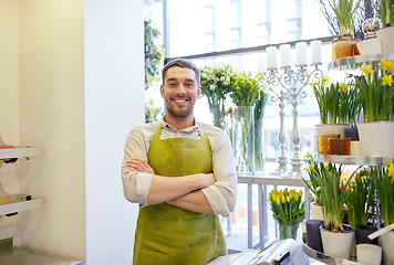 Image showing florist man or seller at flower shop counter