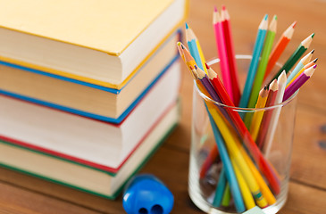 Image showing close up of crayons or color pencils and books