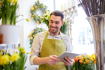 Image showing man with tablet pc computer at flower shop