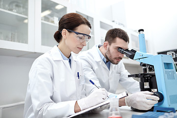 Image showing young scientists making test or research in lab