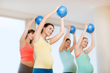 Image showing happy pregnant women exercising with ball in gym