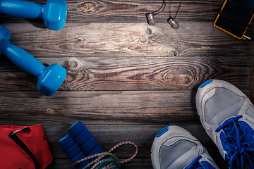 Image showing Sport stuff on wooden table, top view