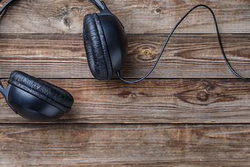 Image showing Headphones over wooden table.