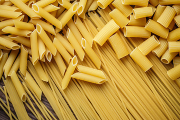 Image showing close up portrait of raw homemade italian pasta, macaroni, spaghetti, and fettuccine