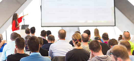 Image showing Female speeker having talk at public event.