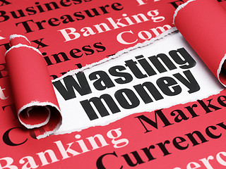 Image showing Money concept: black text Wasting Money under the piece of  torn paper