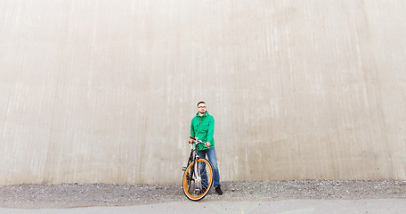 Image showing happy young hipster man with fixed gear bike